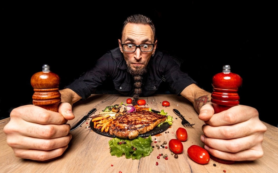 guy eating meat dinner