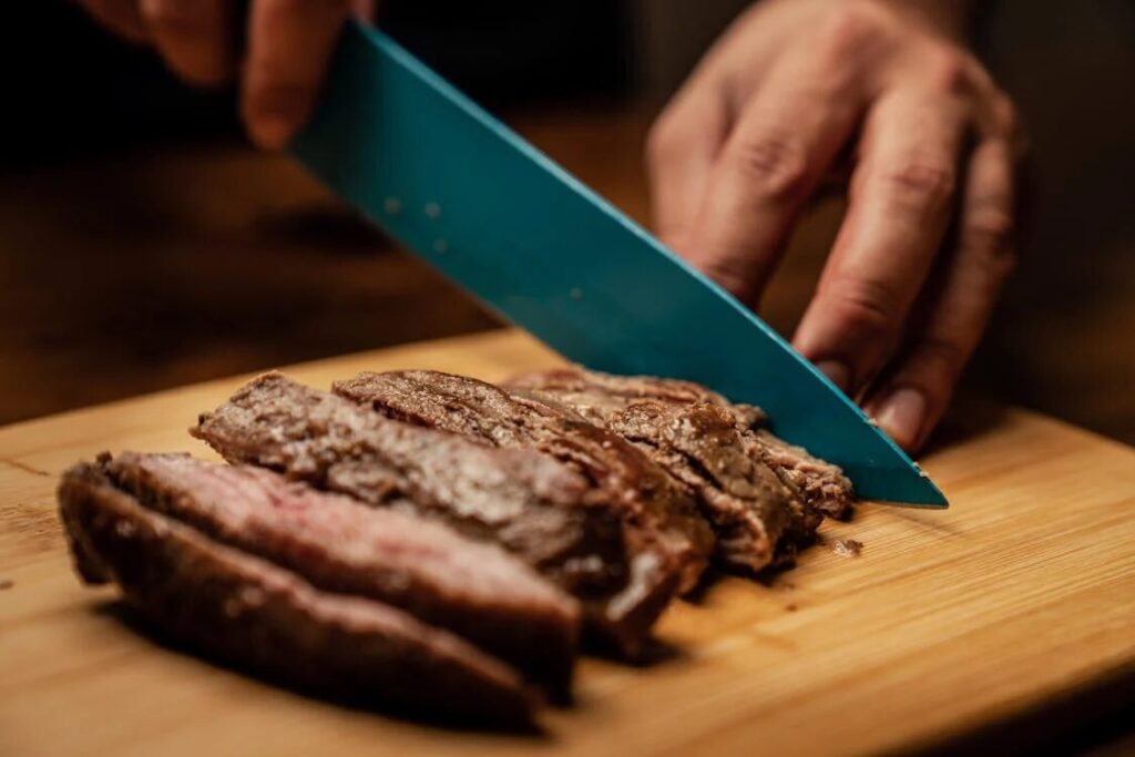 cutting steak on the board