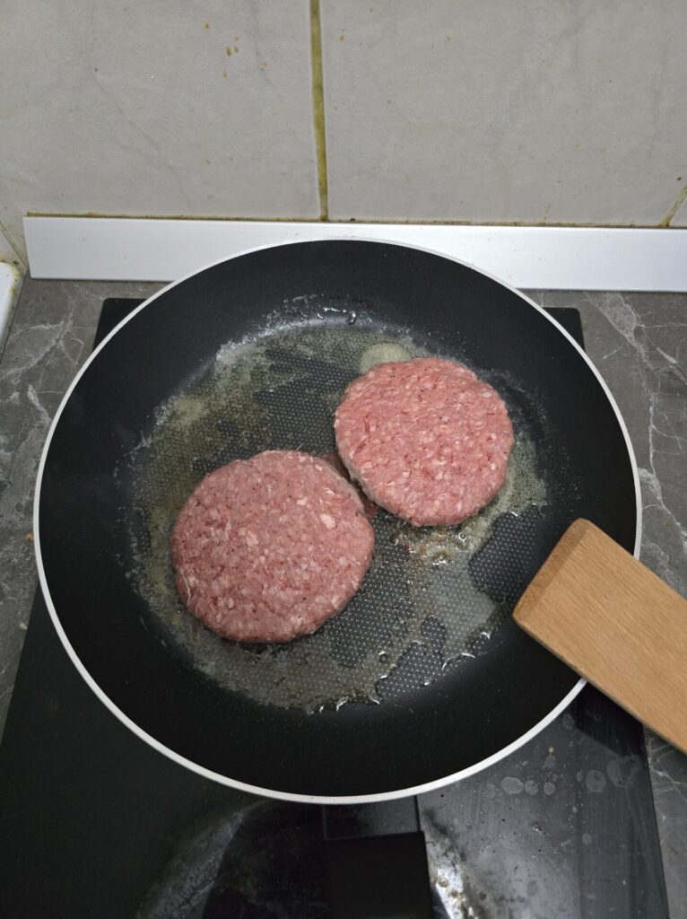 cooking ribeye burgers in the pan