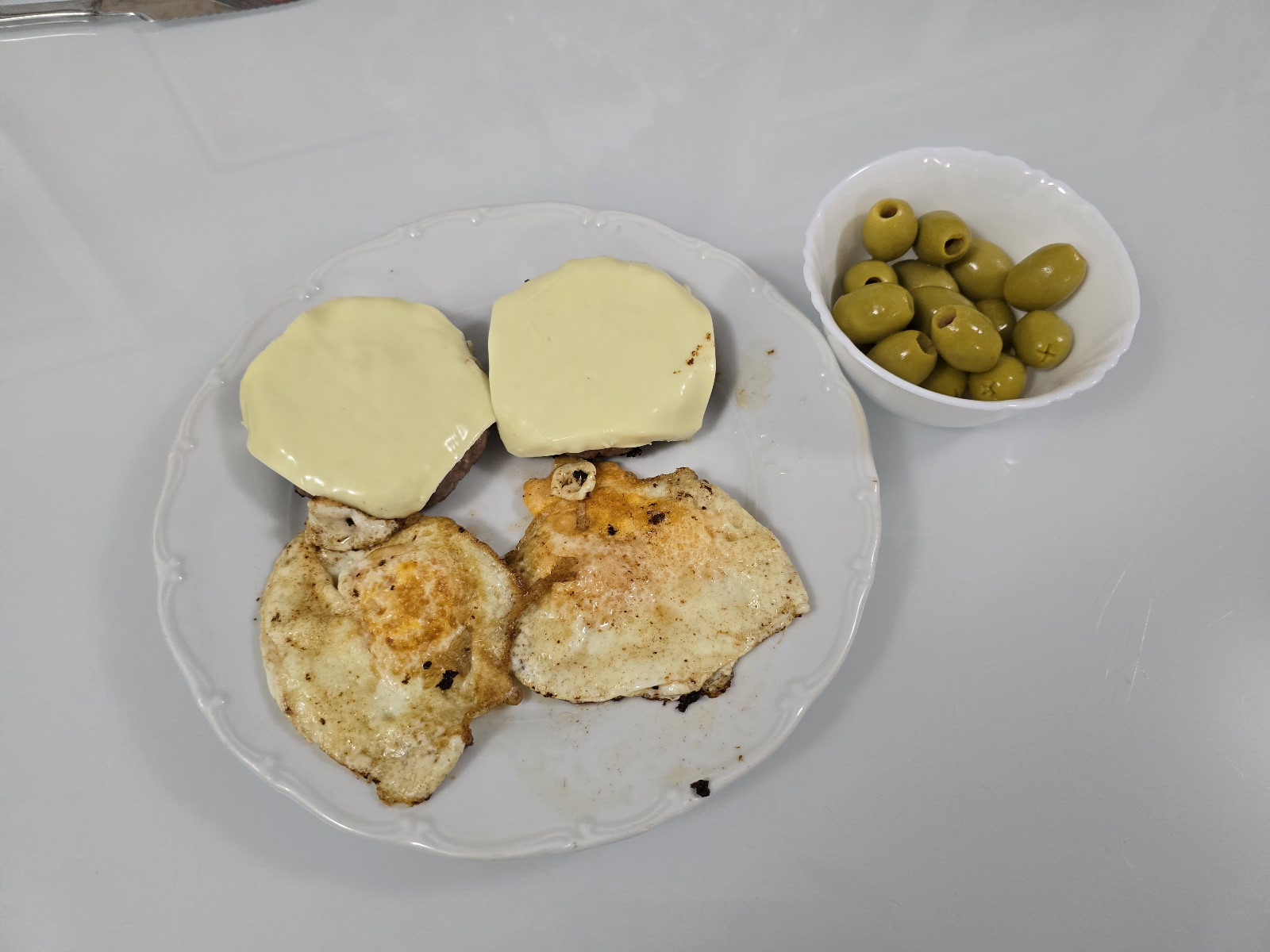 ribeye cheeseburgers with eggs and olives
