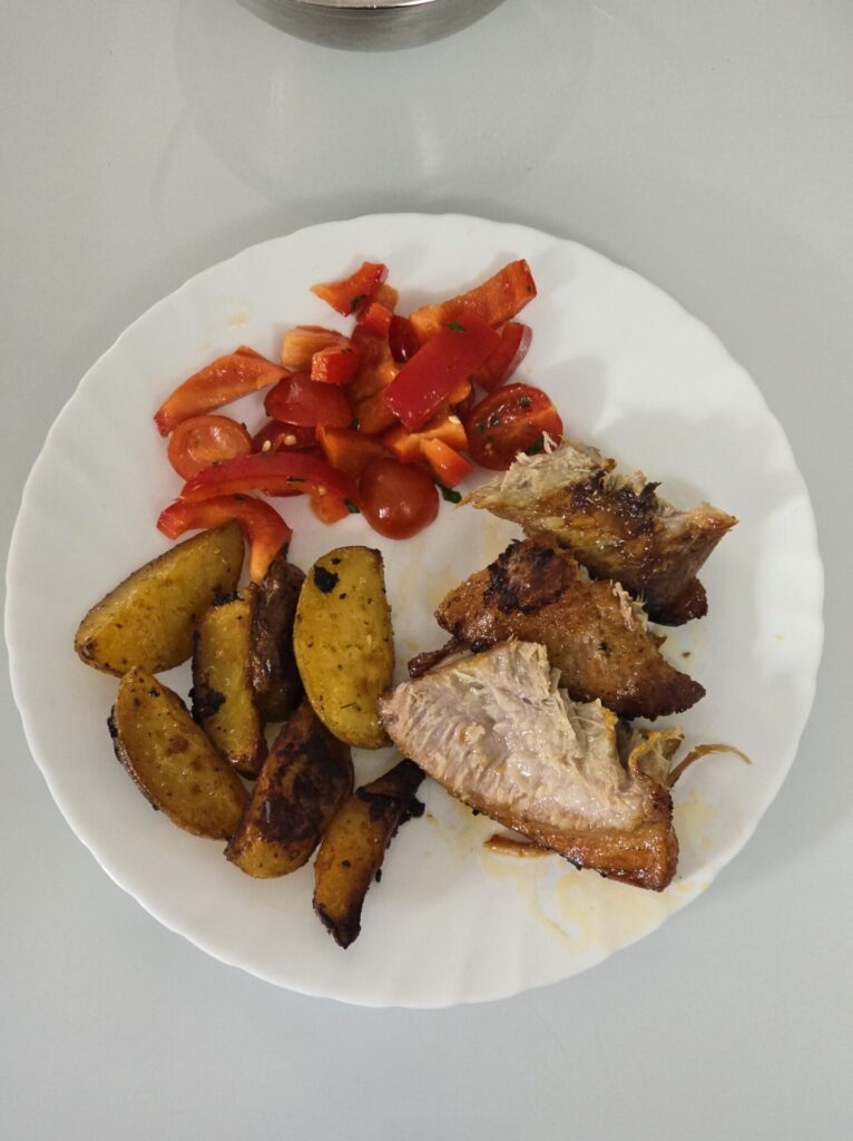 veal ribs and brisket with potatoes and salad on the plate