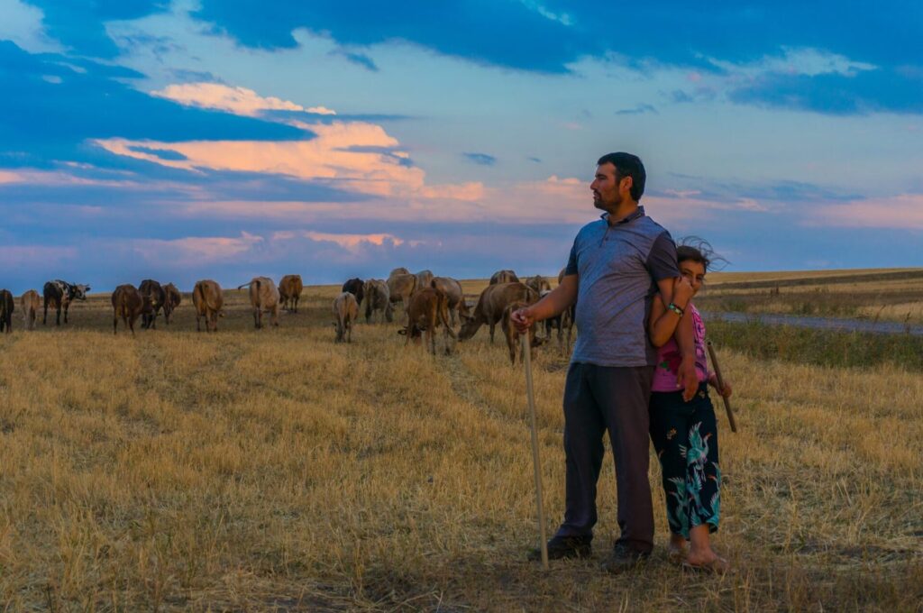 happy farmer with his child and livestock